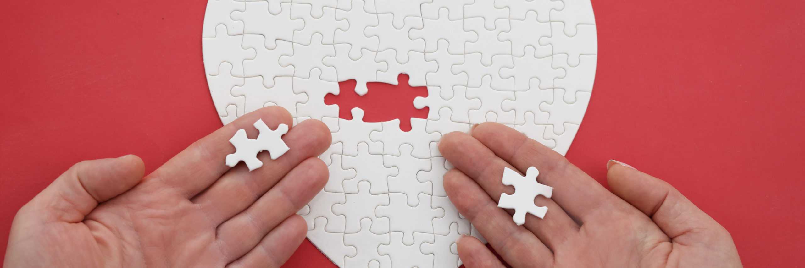 woman-and-a-man-hand-assemble-jigsaw-puzzle-in-shape-of-heart-scaled