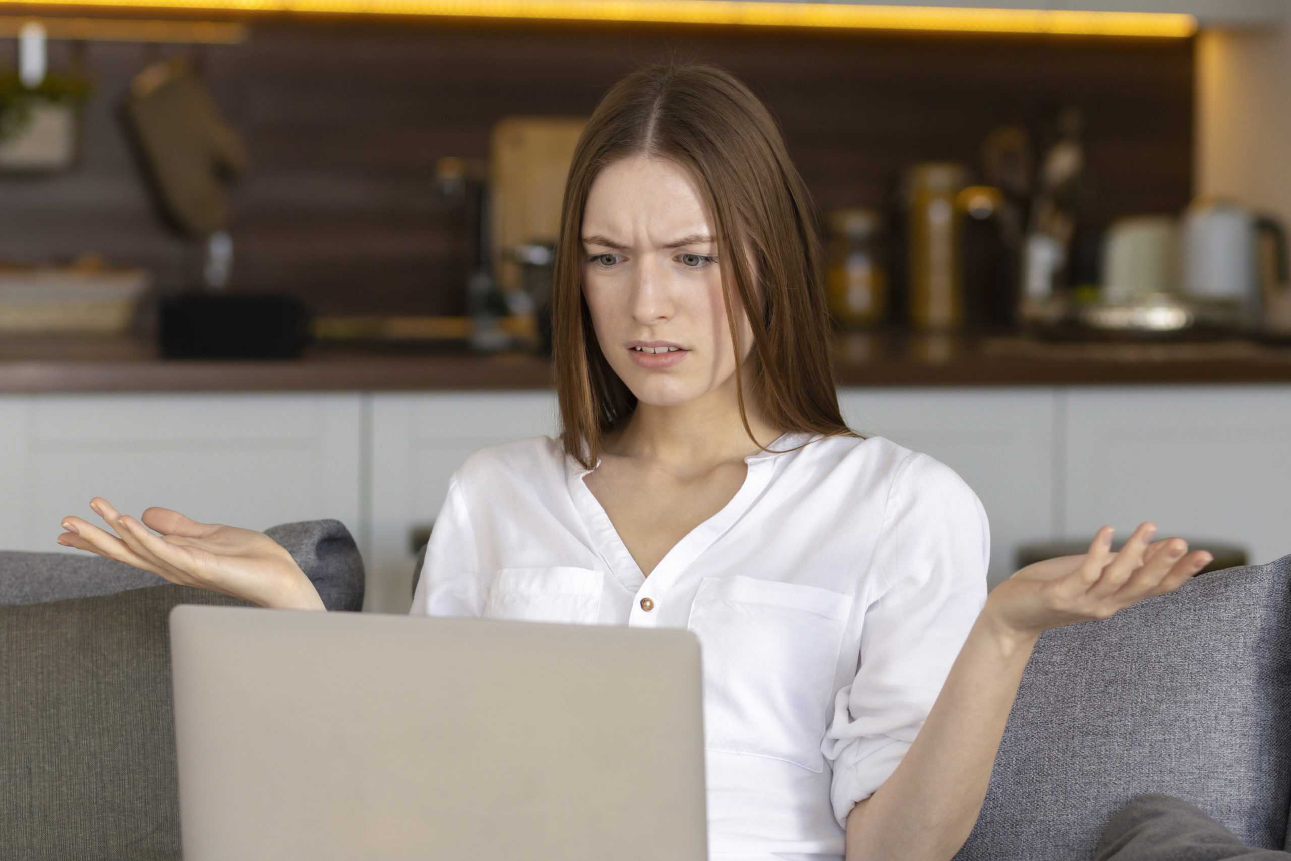 dissatisfied-caucasian-young-woman-looking-laptop-screen-reading-bad-news-message-having-data-los-problem-with-broken-device-scaled