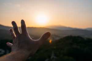 open-hand-direction-horizon-with-beautiful-sunset-300x200