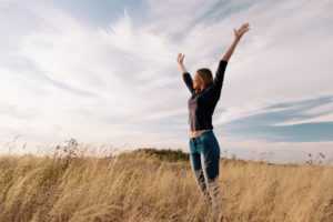 young-happy-woman-in-a-golden-field-on-sunset-300x200