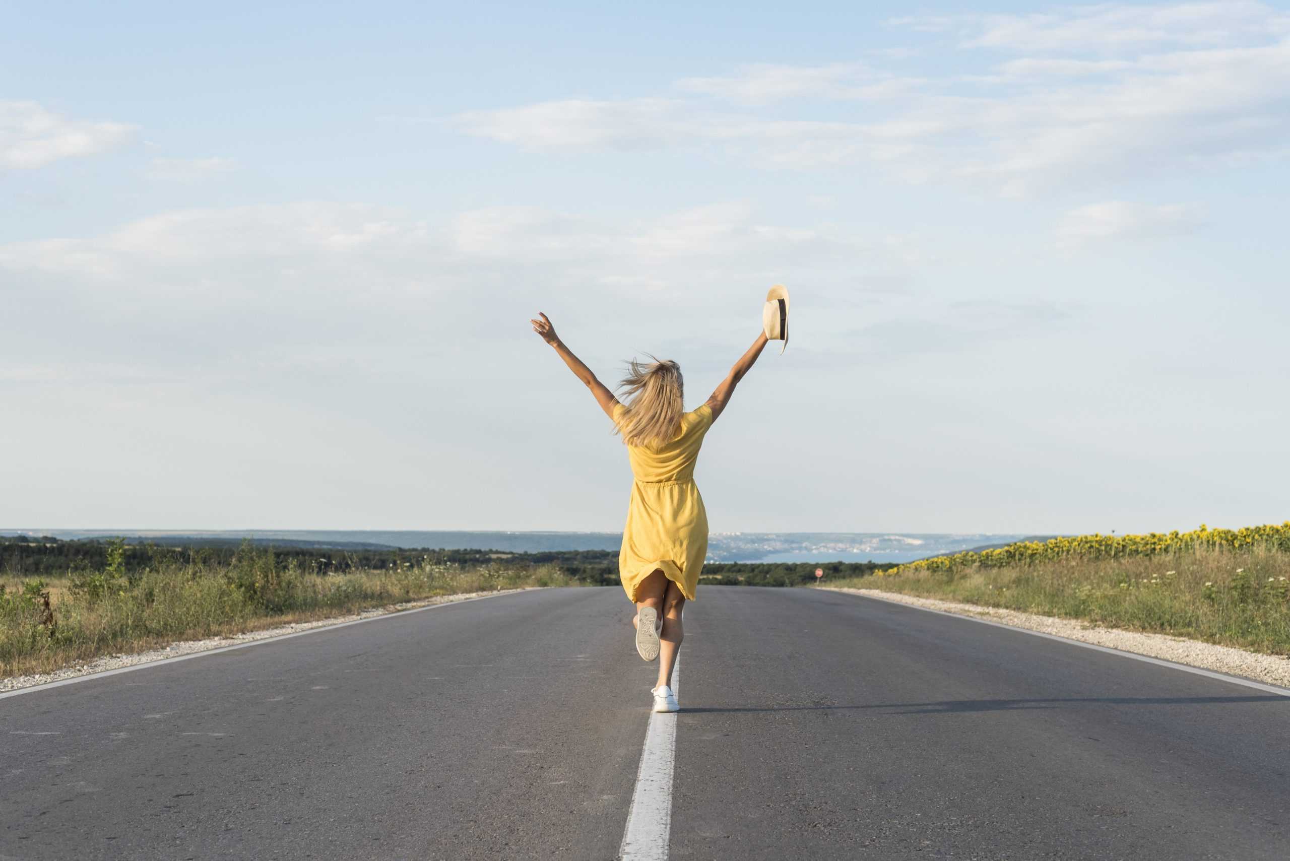 back-view-girl-running-in-the-middle-of-the-street-scaled
