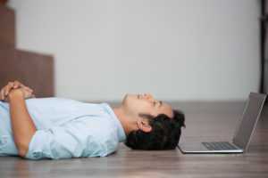 asian-man-lying-on-floor-at-his-laptop-300x200